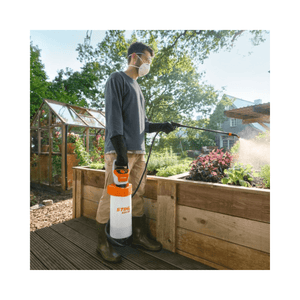 SGA 30 Cordless Backpack Sprayer AS Battery Set in garden, used by man with mask and gloves.