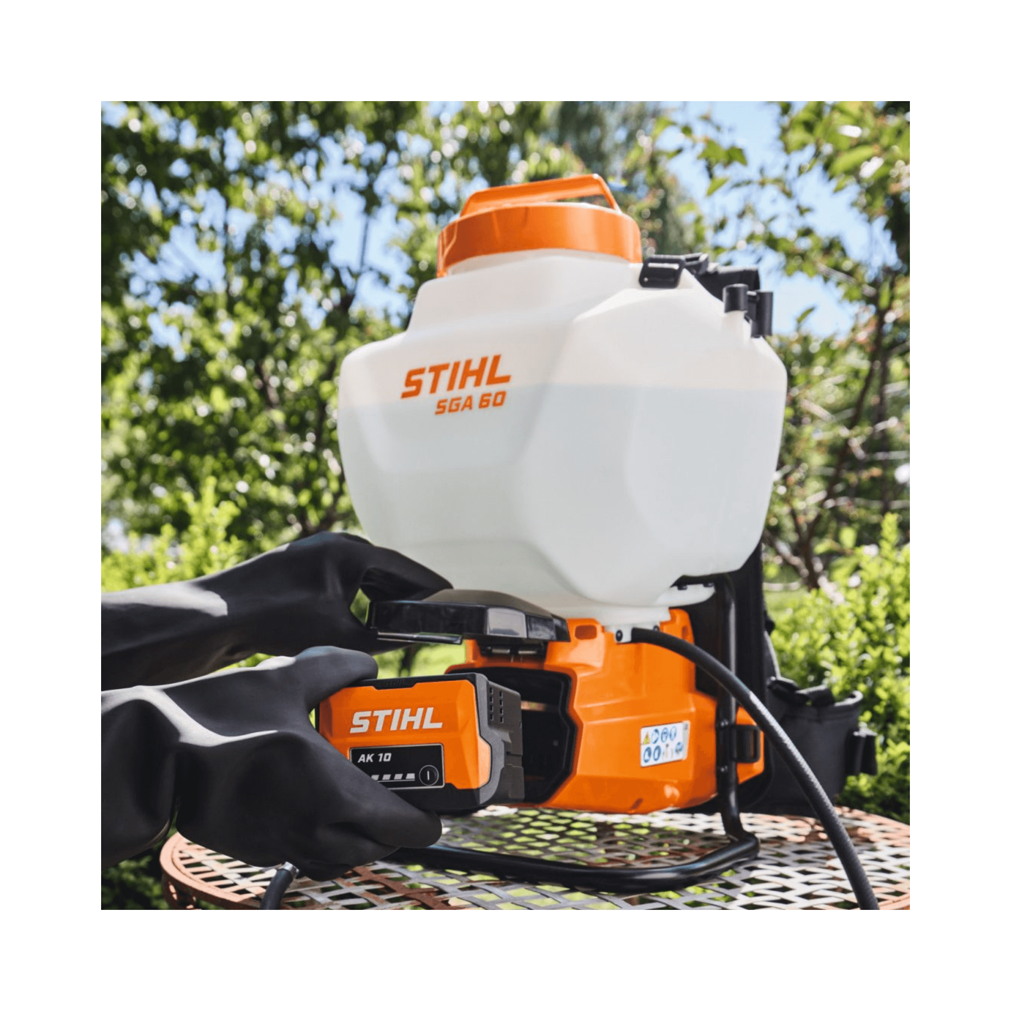 STIHL SGA 60 Cordless Sprayer on a garden table, showcasing its battery and ergonomic design for easy plant treatment.