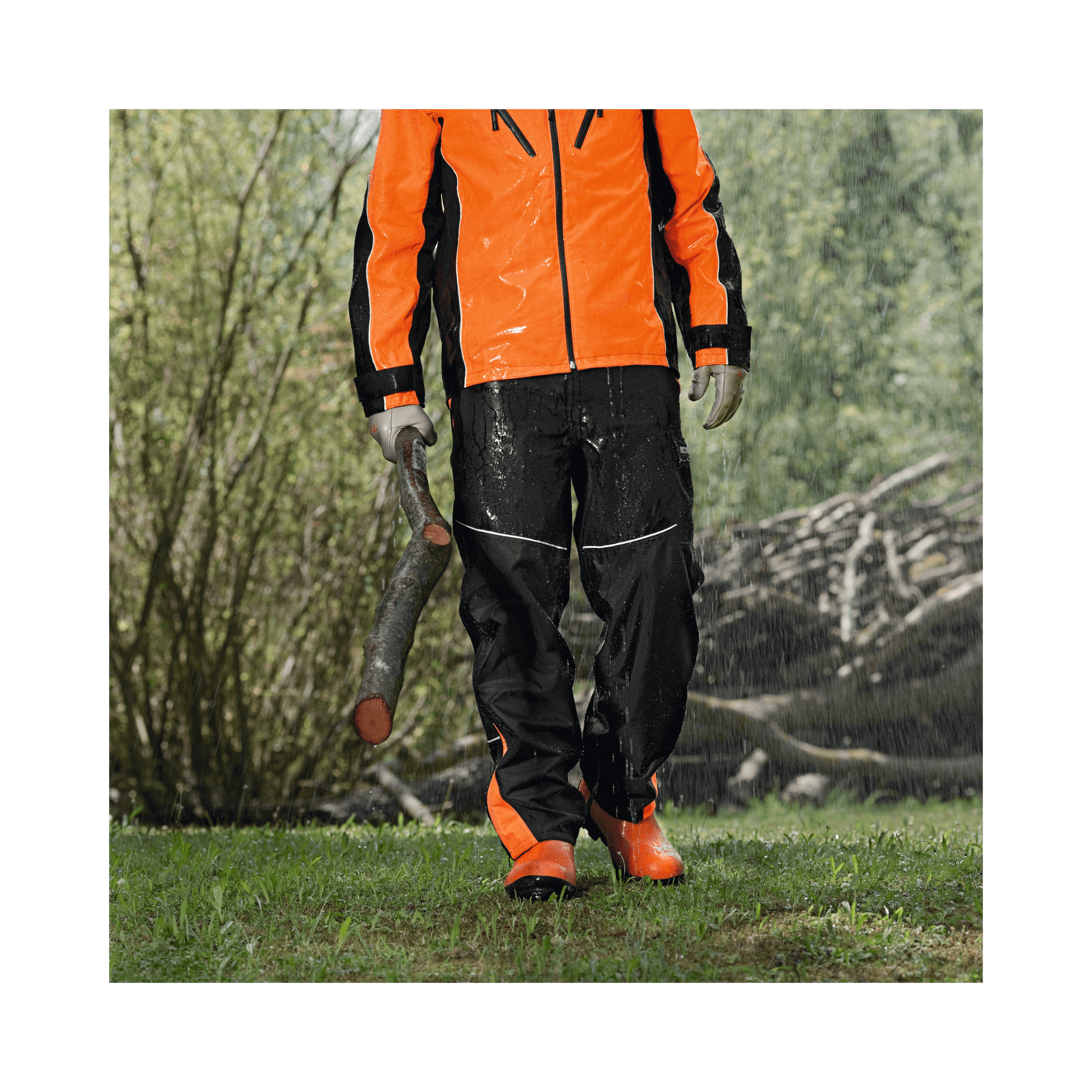 Individual wearing special waterproof gear with rubber boots and protective gear, showcasing outdoor forestry work.