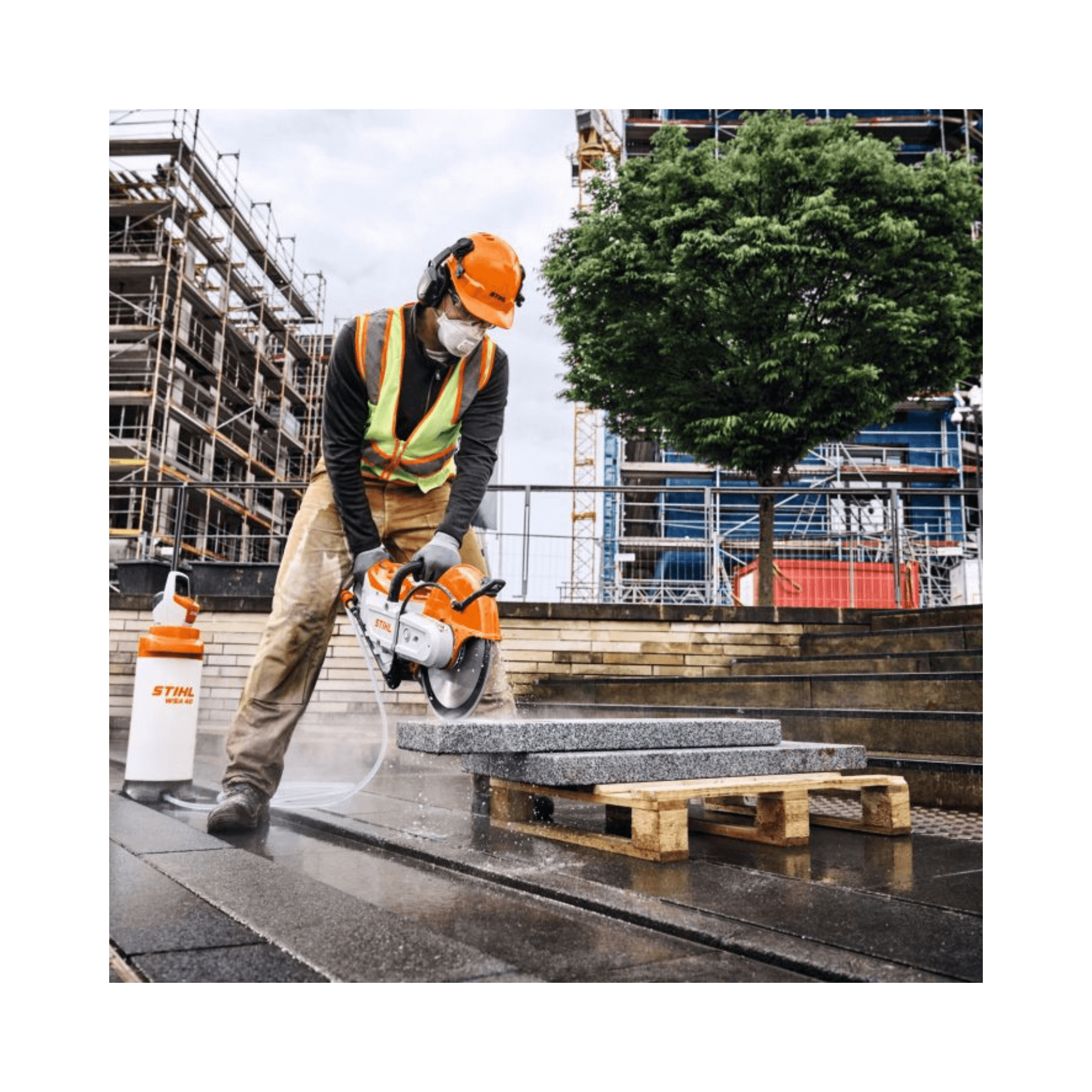 Worker using TSA 350 Cordless 14" Disc Cut-Off Machine on stone in construction site, ideal for Arborist and tree surgeon tasks.