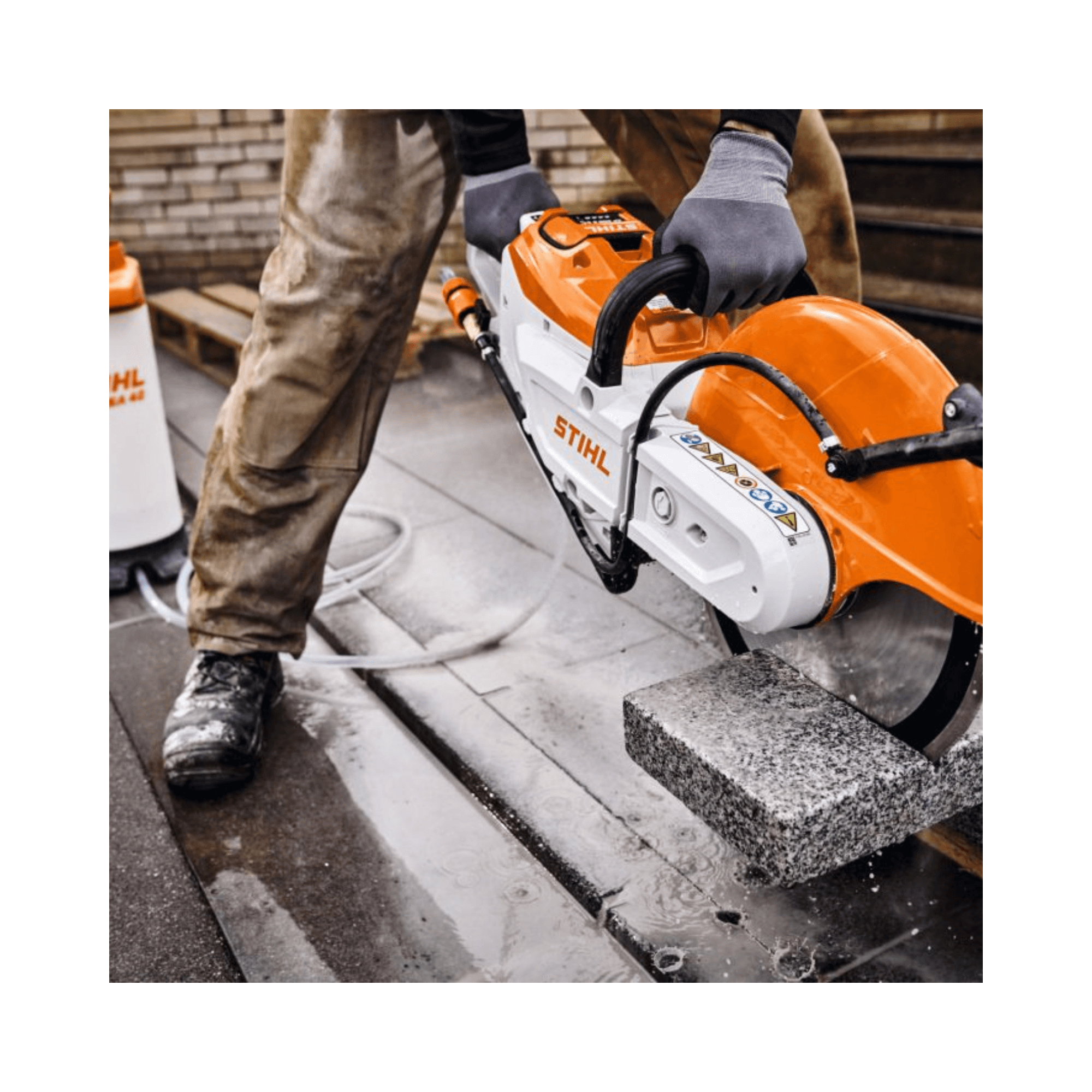 STIHL TSA 350 Cordless 14" Disc Cut-Off Machine in action cutting through concrete block.