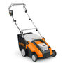 Stihl RLA 240 cordless scarifier/aerator. Orange machine with rotating blades for lawn care. Battery-powered.