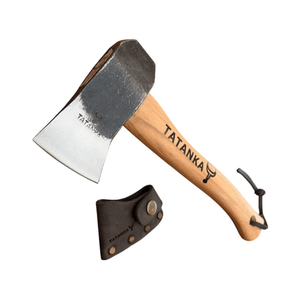 A hand axe with a natural wood handle and a dark steel head, shown alongside a black leather sheath. The handle and head are both printed with the brand name 'TATANKA'.