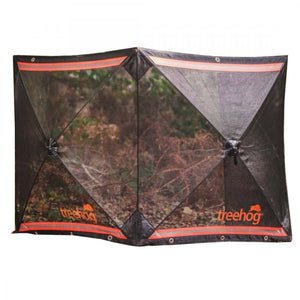 A black mesh stump grinding guard system with the TreeHog brand visible, designed to protect against flying debris during tree stump grinding.