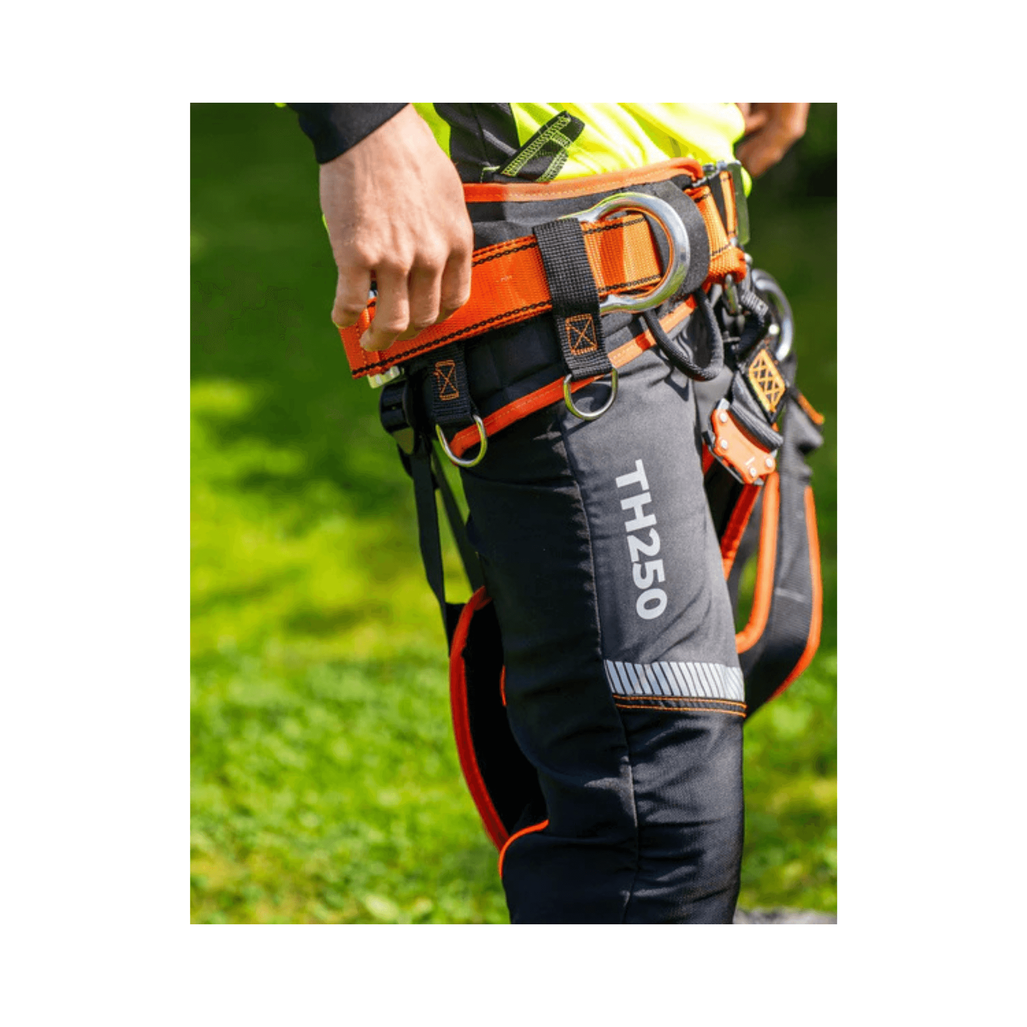 Close-up of TH250 Essential Class 1 chainsaw trousers showing safety features and straps for secure fit.