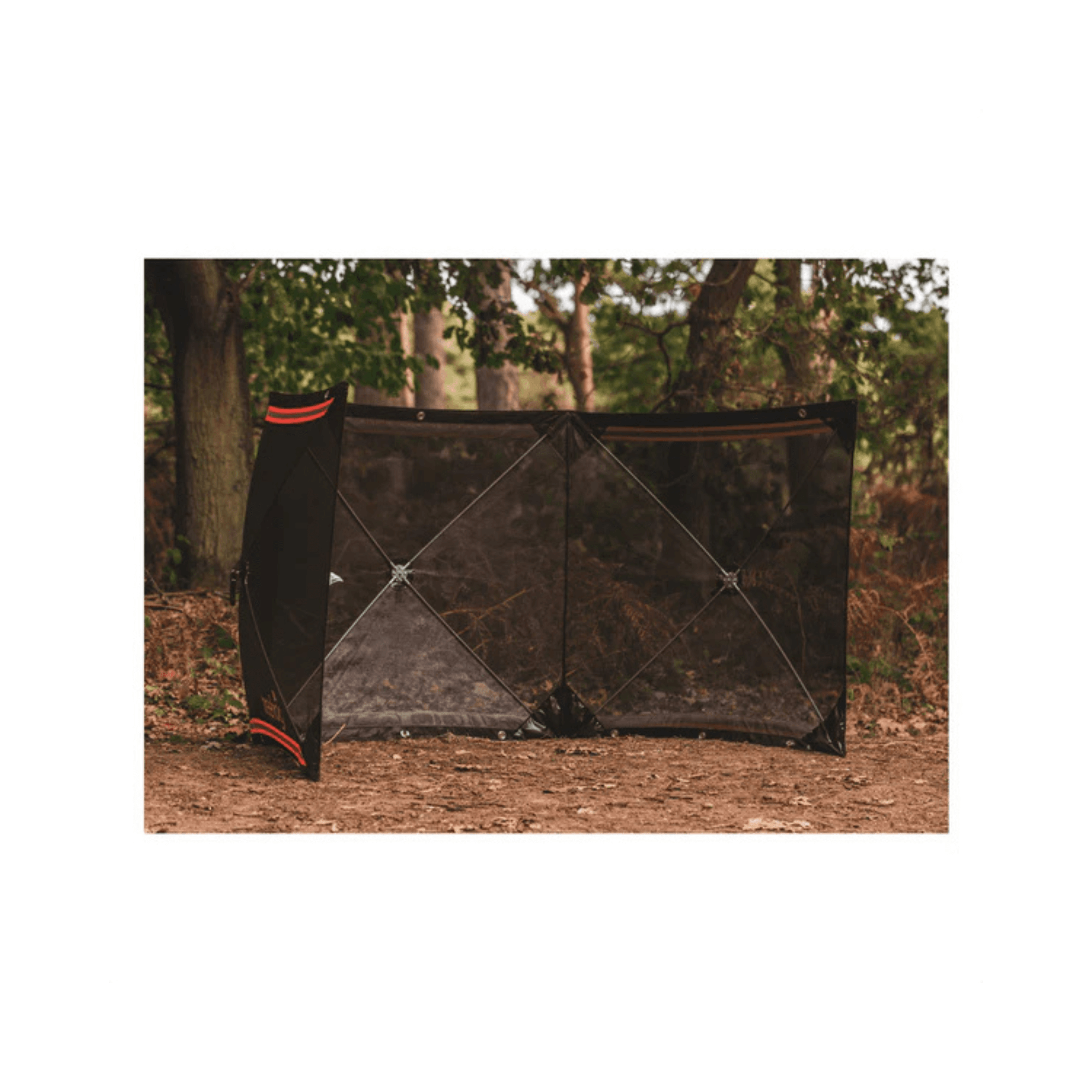 TreeHog Mesh Stump Grinding Guard System set up in a wooded area, providing safety for tree surgeons.