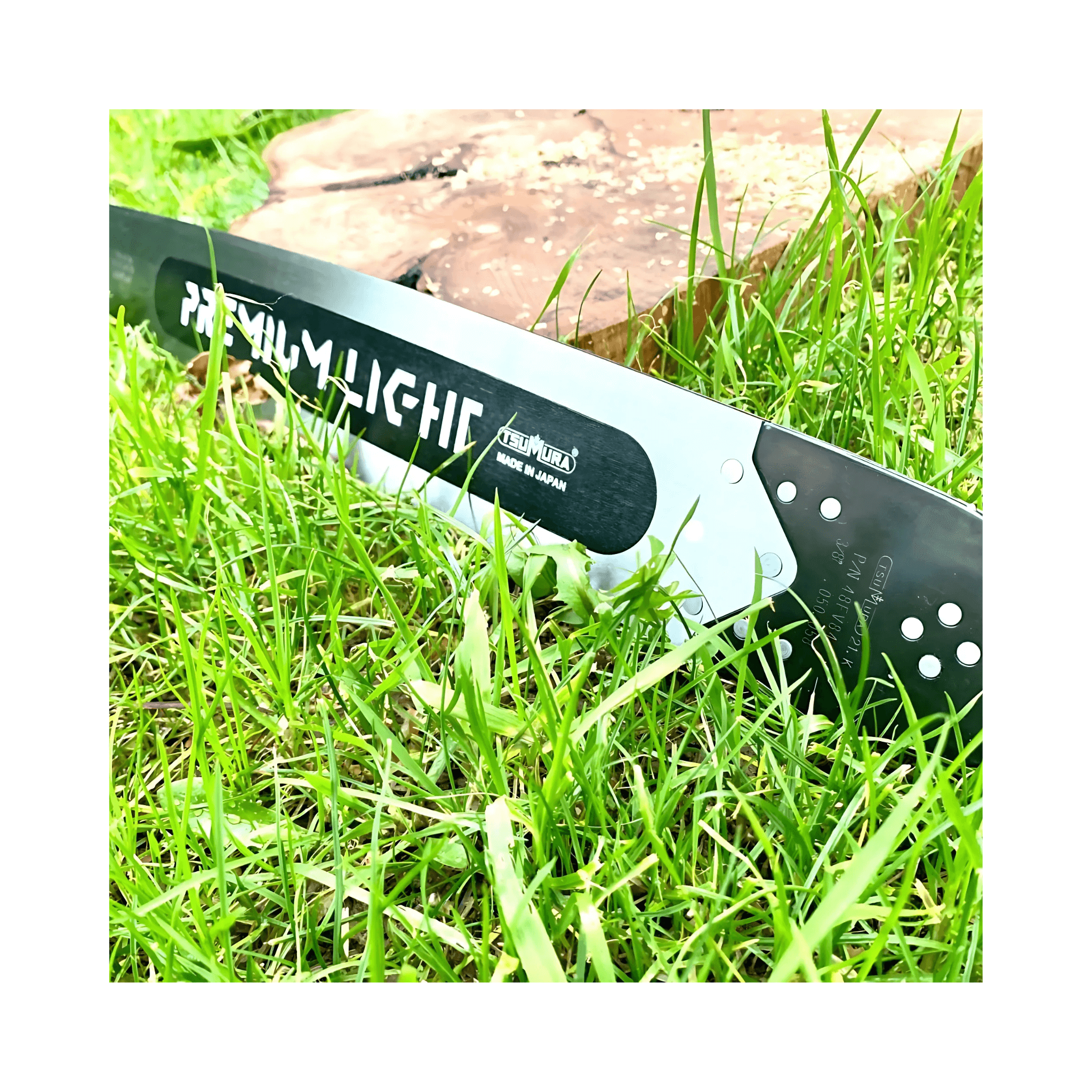 Tsumura Light Bar Black Edition on grass, durable chainsaw bar designed for precision cutting by tree surgeons.
