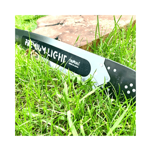 Tsumura Light Bar Black Edition on grass, durable chainsaw bar designed for precision cutting by tree surgeons.