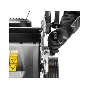 Close-up of a hand adjusting the lever on a Virtue 46 SVP petrol lawn mower, showcasing user-friendly controls for effective mowing.