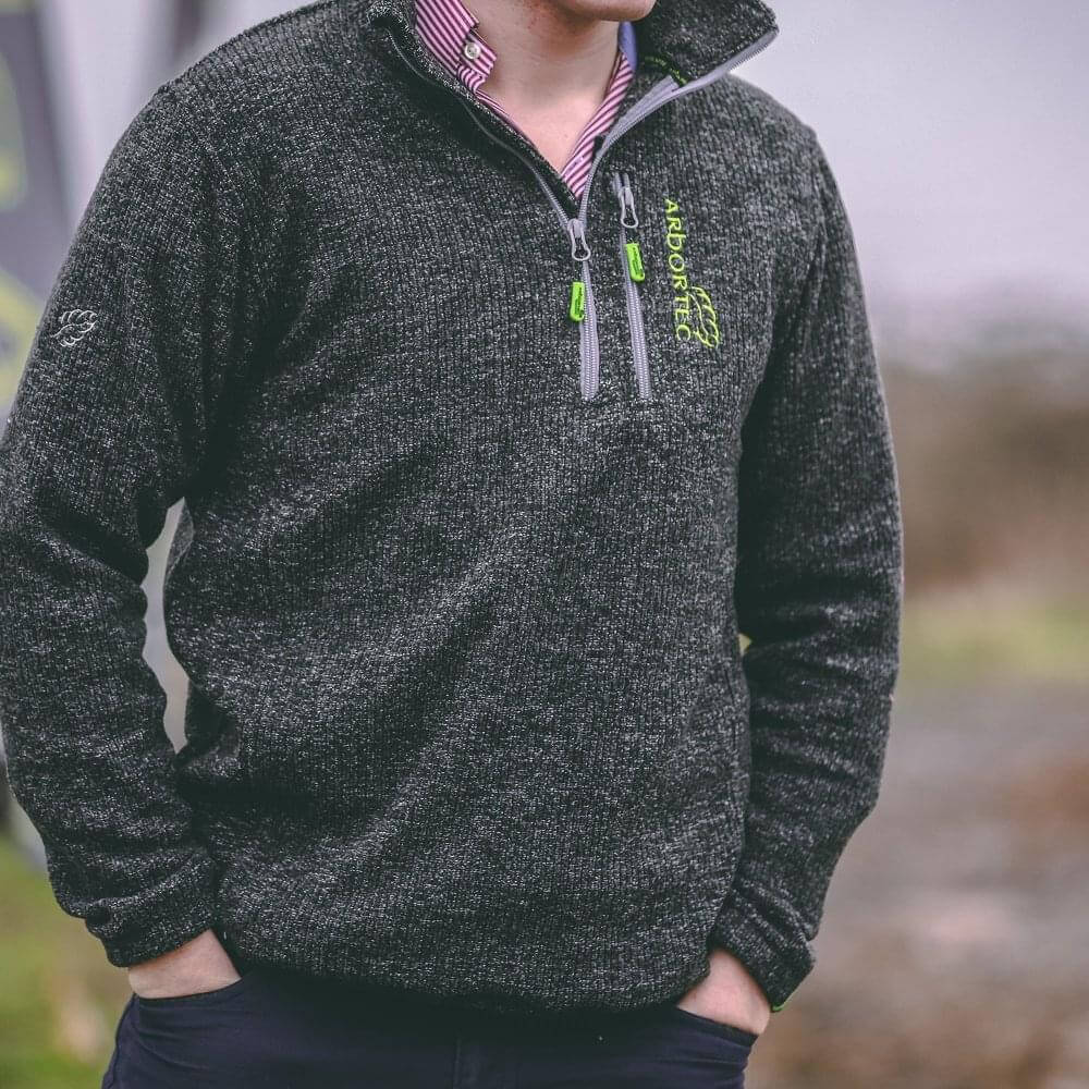 Man wearing the Wolf Half-Zip Knitted Fleece in grey, perfect for tree surgeons and outdoor work.