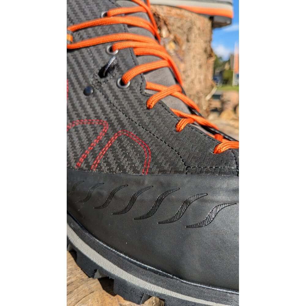 Close-up of EVO chainsaw boots featuring durable materials and orange laces, ideal for tree surgeons and arborists.