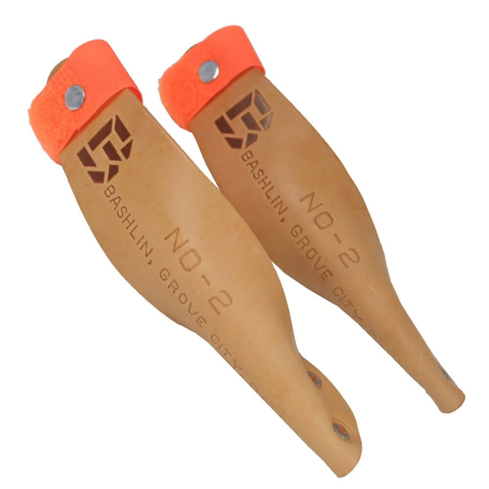 Bashlin gaff guards for climbing spikes, designed for tree surgeons, featuring leather construction and bright orange straps.