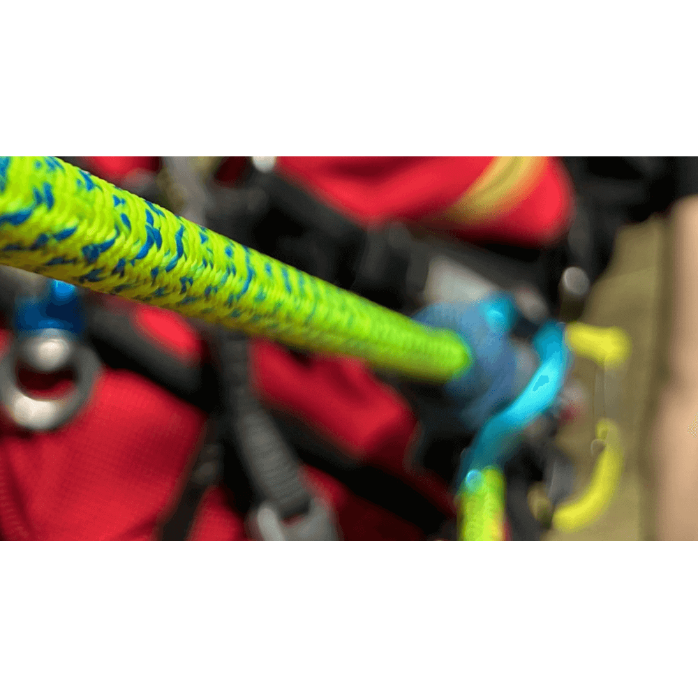 Close-up of the bright yellow and blue Flexbee V2 Snapo Prusik rope lanyard used by a tree surgeon.