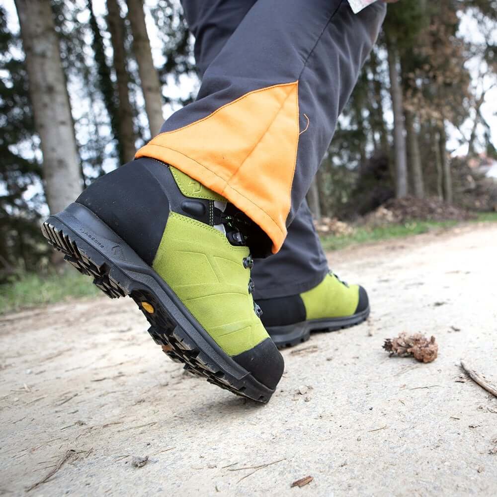 Close-up of Haix Protector Ultra 2.0 GTX chainsaw boots on a forest path, designed for tree surgeons.