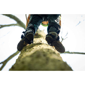 Tree surgeon wearing Ergo Steel Climbers while ascending a tree, showcasing comfort and support features.