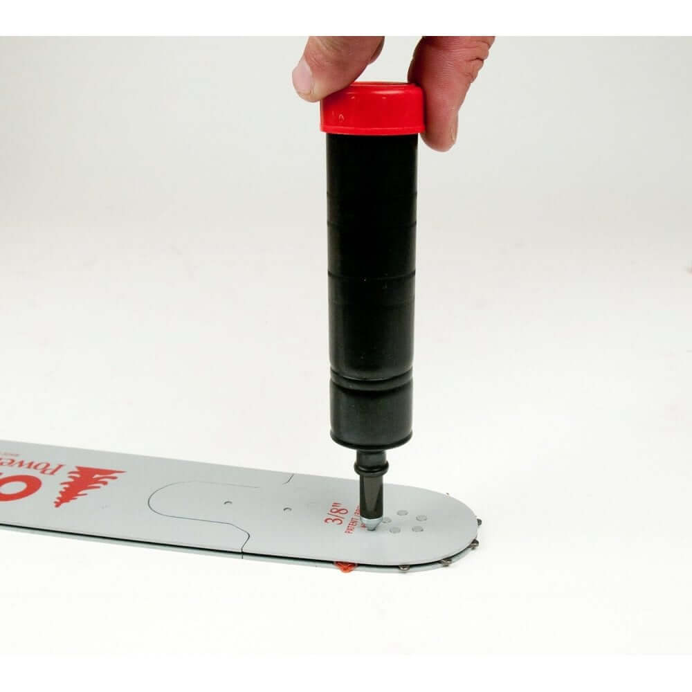 Oregon Grease Gun lubricating a chainsaw guide bar, essential for tree surgeons to maintain optimal chainsaw performance.