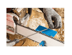Tree surgeon sharpening a chainsaw blade using a round file and sharpening guide.