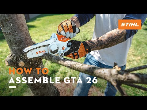 User assembling the STIHL GTA 26 cordless garden pruner for effective tree surgery.