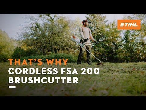 Professional using STIHL FSA 200 cordless brushcutter for landscaping and gardening tasks.