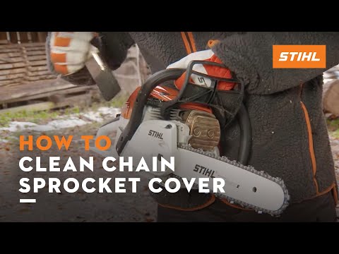 User demonstrating how to clean the chain sprocket cover of a STIHL chainsaw in a forest setting.