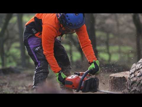 Breatheflex Chainsaw Trousers Lime Design Type C Womens worn by a tree surgeon cutting wood with a chainsaw.