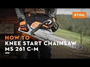 User demonstrating how to knee start the STIHL MS 261 C-M petrol chainsaw in an outdoor setting.