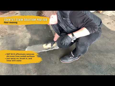Person using Biological Stain Solution Pro ECO - 1l Sprayer to clean dirt from a floor surface.