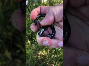 Tree Locki+Sigyn Accessory Carbiners held in hand outdoors, demonstrating practical use and innovative design.