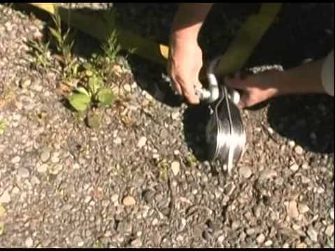 Person using Portable Winch Single Swing Side Pulley Sheave 100mm for lifting tasks outdoors, ideal for tree surgeons.