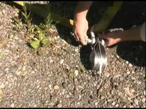 Person using Portable Winch Single Swing Side Pulley Sheave 100mm for lifting tasks outdoors, ideal for tree surgeons.