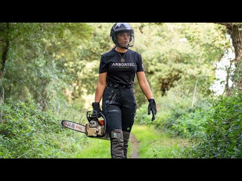 Breatheflex Pro Womens Chainsaw Trousers Type C Black worn by a female arborist in a forest with a chainsaw.