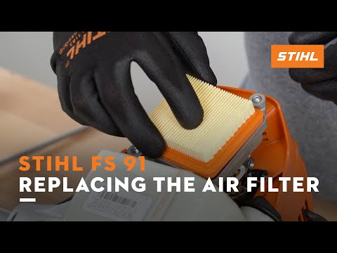 Person replacing air filter on STIHL FS 91 brush cutter, ideal for tree surgeons. Maintenance for optimal performance.