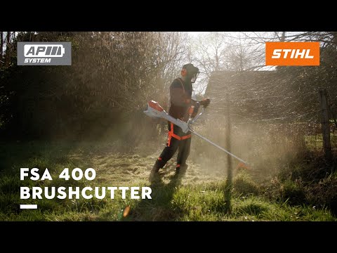 Professional using STIHL FSA 400 cordless clearing saw for landscaping, ideal for tree surgeon tasks.