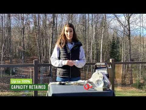 Woman demonstrating RopeWizer Heavy Duty Thimble for maximizing rope performance in a forest setting.
