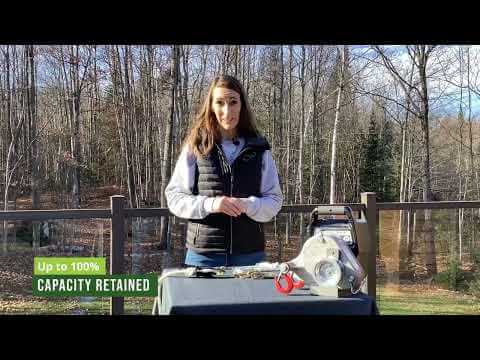 Woman demonstrating RopeWizer Heavy Duty Thimble for maximizing rope performance in a forest setting.