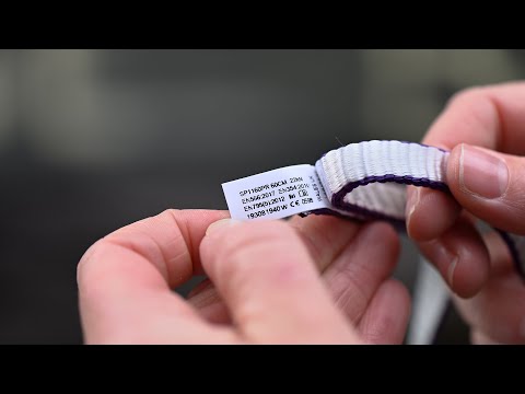 Person holding a DMM Dynatec Rope Slings 11mm with label showing specifications and product details.
