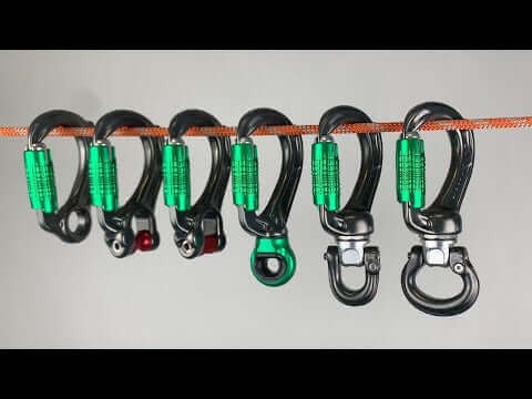 Various DMM Director Swivel Eye Locksafe carabiners hanging on a rope, ideal for climbing, caving, and tree surgeons.