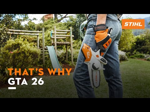 STIHL GTA 26 cordless pruning saw held by a gardener in a lush garden setting, ideal for tree surgeons and precision pruning.