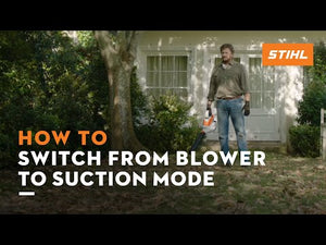 Man demonstrating how to switch STIHL SHA 56 from blower to suction mode in a garden setting.