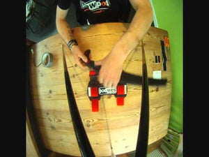 Person demonstrating the Darbyshire Sawpod pruning saw holster on a wooden table for tree surgeons.