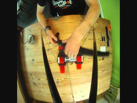 Person demonstrating the Darbyshire Sawpod pruning saw holster on a wooden table for tree surgeons.