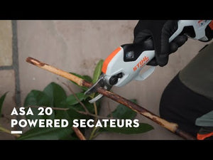 User using ASA 20 Cordless Secateurs to cut a branch with precision during a gardening task.