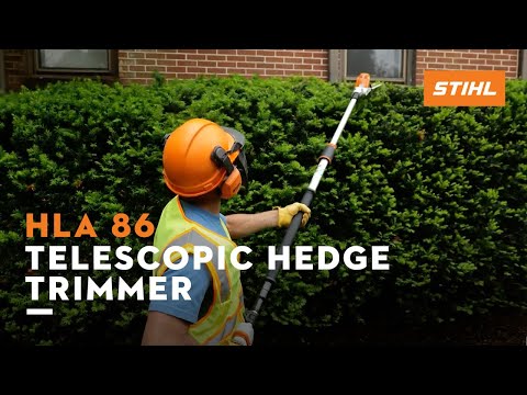 Professional using STIHL HLA 86 Telescopic Hedge Trimmer for tall hedges, ideal for Tree Surgeons.