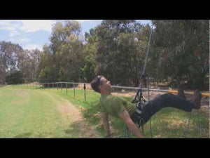 Tree surgeon demonstrating the ART SpiderJack 2.1 rope control device in an outdoor setting.