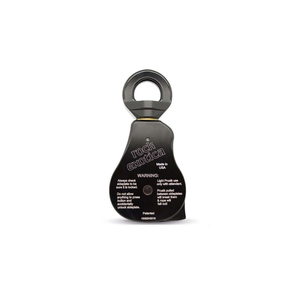 Rock Exotica Omni 2.6" swivel pulley with warning label for safety and usage instructions.