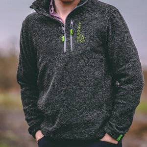Model wearing Arbortec Wolf Half-Zip Knitted Fleece in grey, ideal for tree surgeons and outdoor activities.